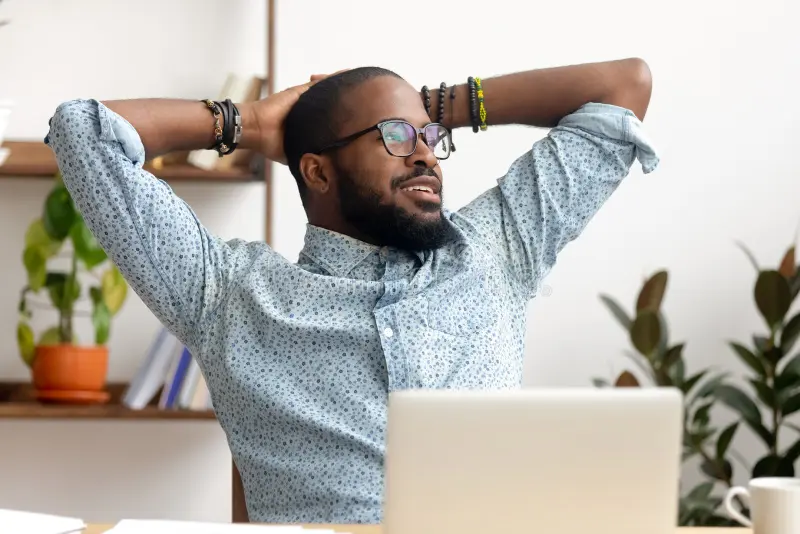 african man relaxing at workplace